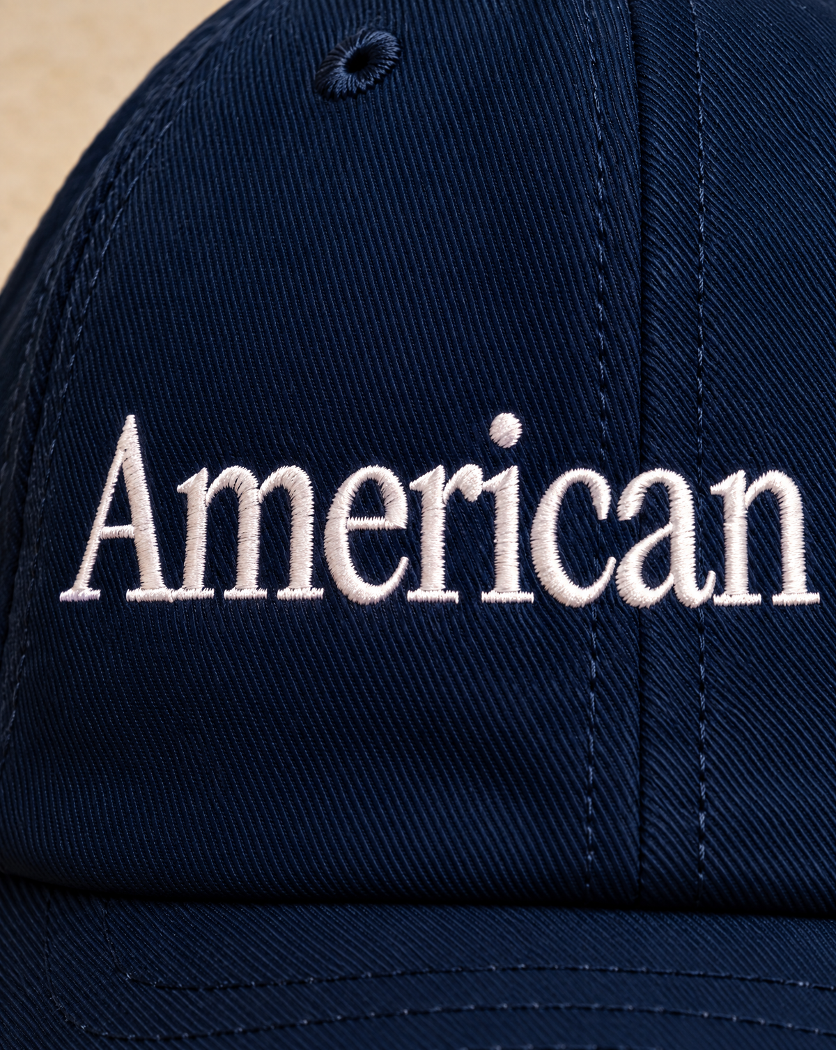 Close-up of the white American Empire embroidery on the navy hat