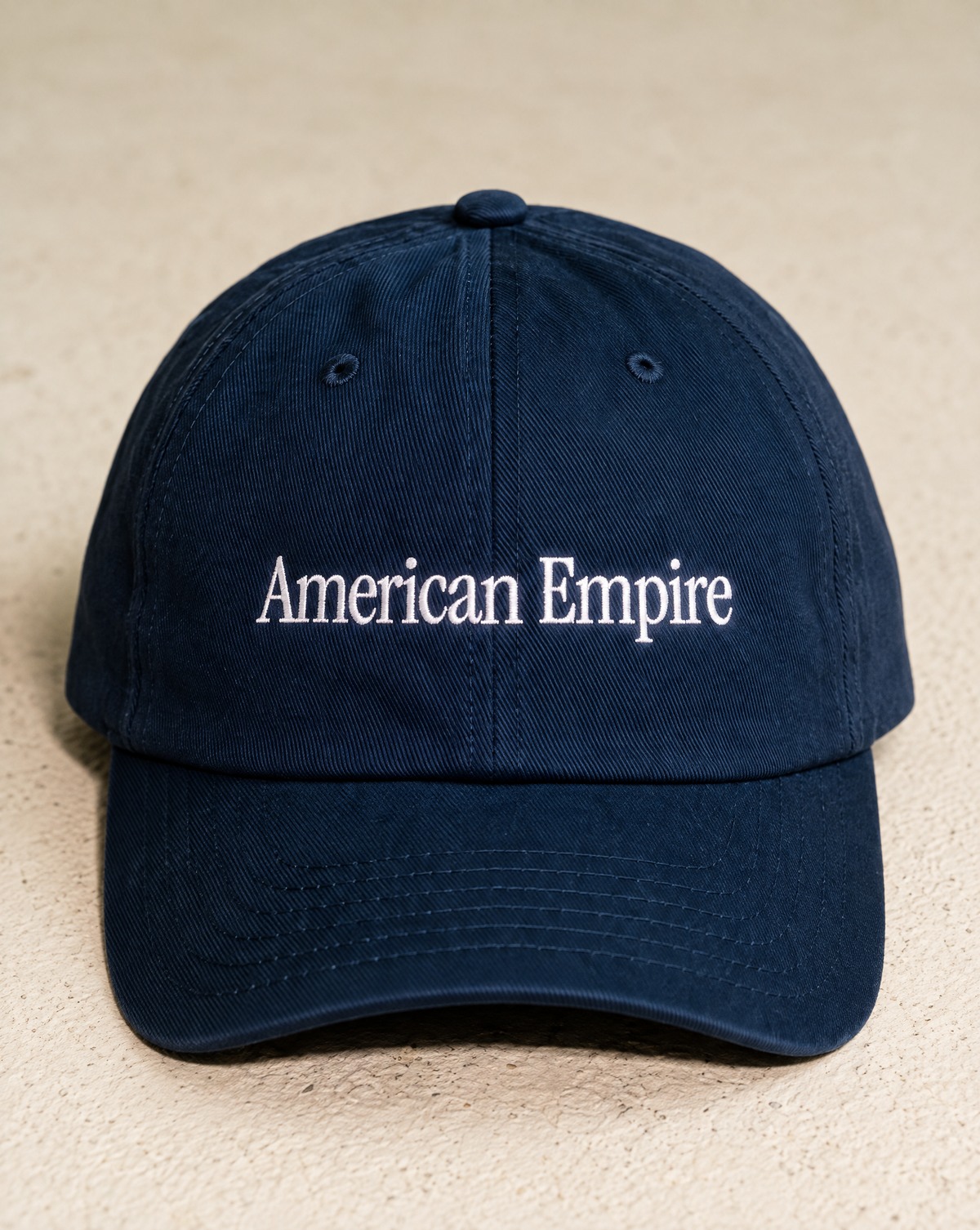 Navy American Empire hat with white embroidery, front view
